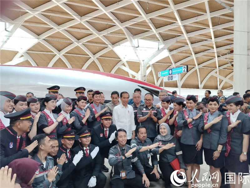 印尼總統(tǒng)佐科與雅萬(wàn)高鐵乘務(wù)員及中印尼嘉賓合影。人民網(wǎng)記者 李培松攝