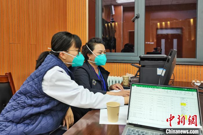 8月9日，楊蘇喬(左)在拉薩方艙醫(yī)院指揮部讀取艙內(nèi)患者胸部CT?！∈茉L者供圖