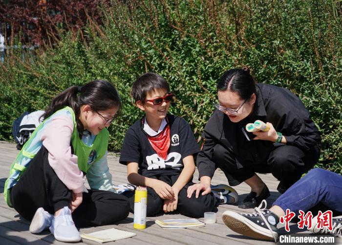 圖為小朋友在青海西寧湟水國家濕地公園內(nèi)認識植物并進行繪畫。　馬銘言 攝