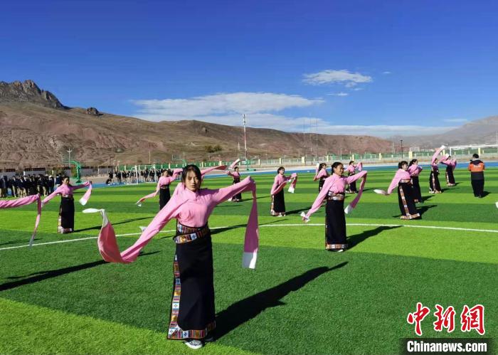 圖為青海師范大學(xué)附屬玉樹實驗學(xué)校學(xué)生在綠茵場跳起囊謙古舞—卓根瑪?！“讋?攝