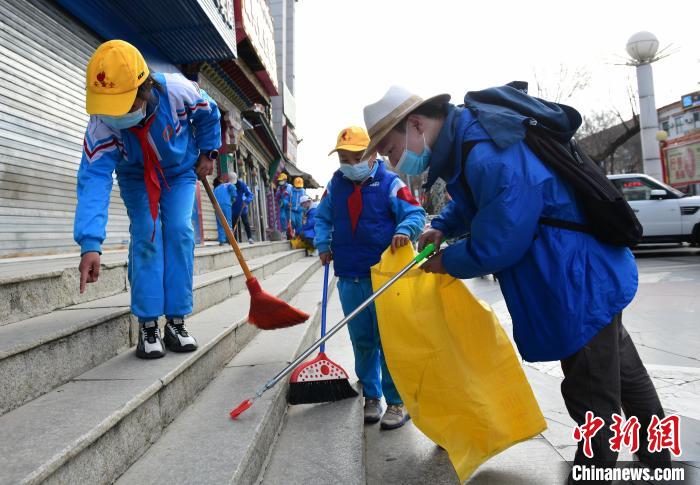 圖為拉薩市小學(xué)生打掃街道。　貢嘎來松 攝