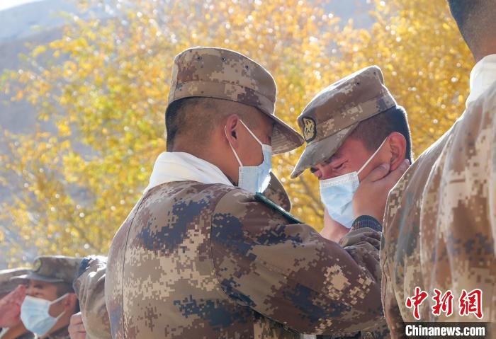 圖為什布奇邊防連退伍老兵與戰(zhàn)友相擁而泣，依依惜別?！⌒觳?攝